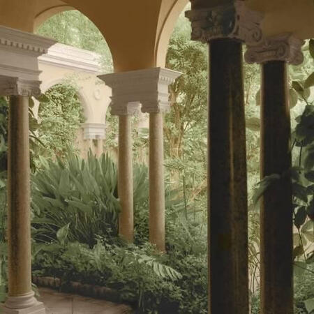 Photo of creme colored arches and green trees or bushes.